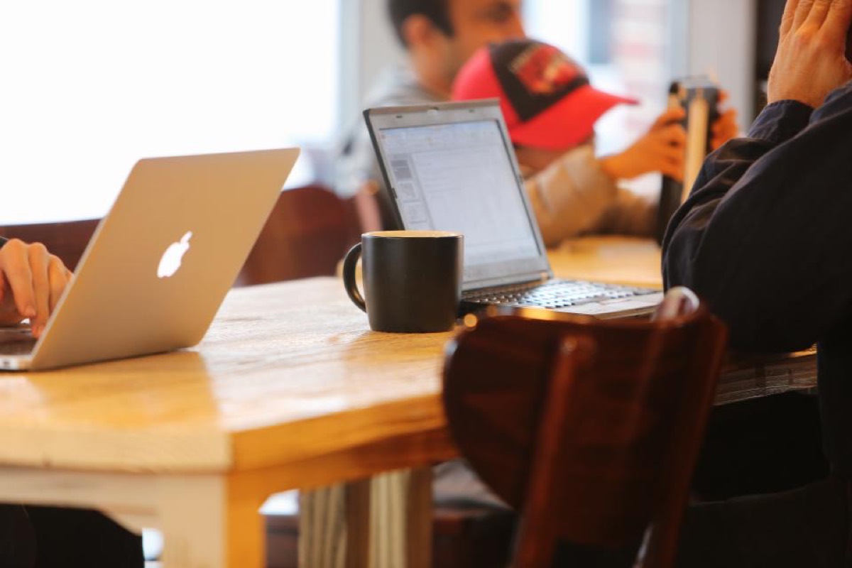 People working together on laptops at a desk