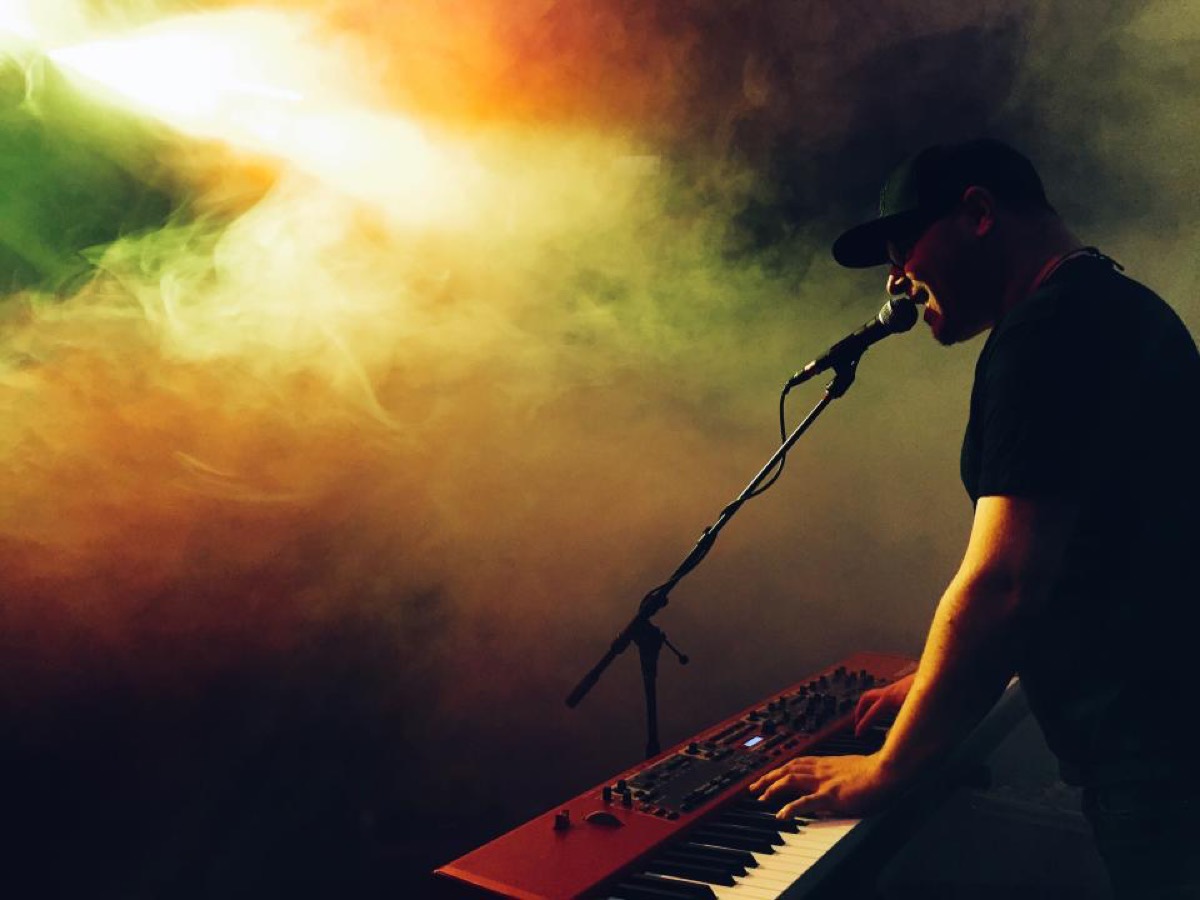 A worship musician singing into a microphone