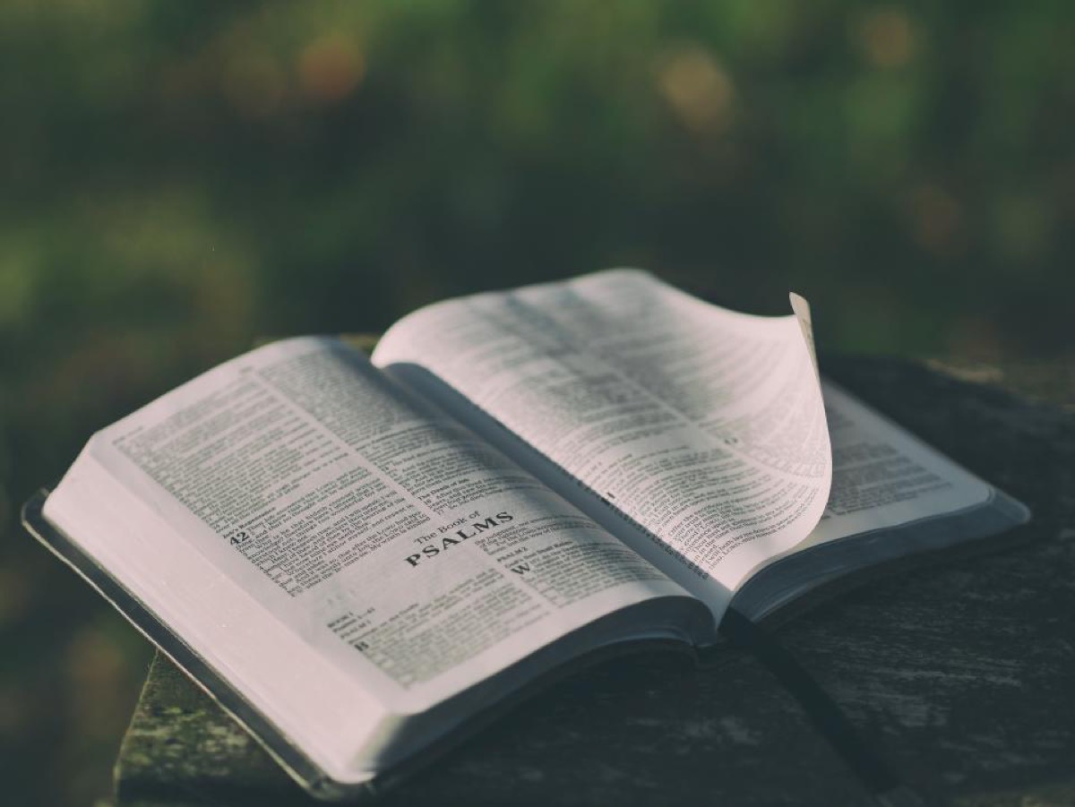 An open Bible resting on a wooden surface